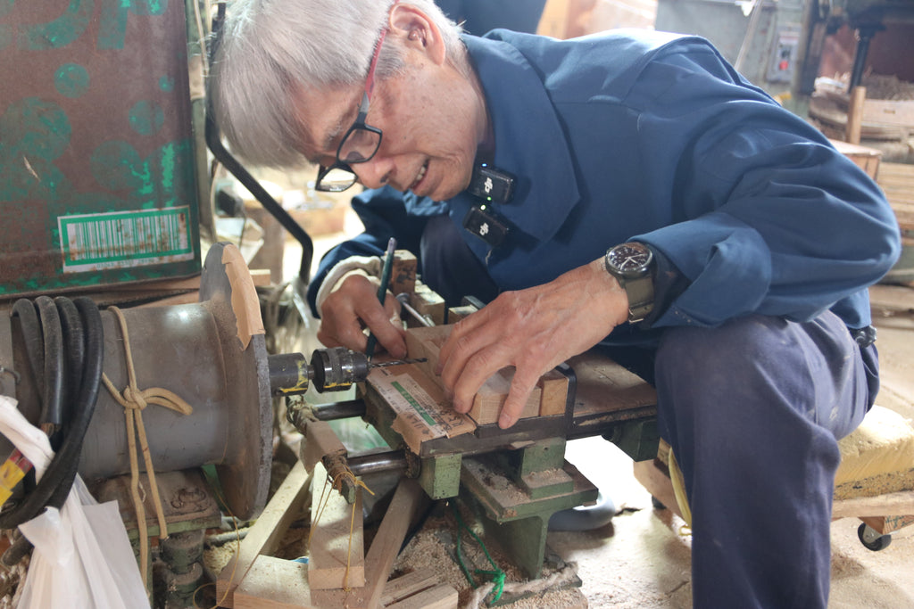A craftsman drills a hole in the side of a plane body at Kanai Woodworks to attach the pin that secures the chip breaker.