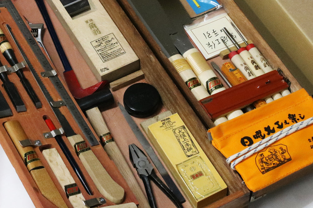 Close-up of a traditional Japanese woodworking tool set from Kakuri, showcasing various high-quality tools and accessories for craftsmen.