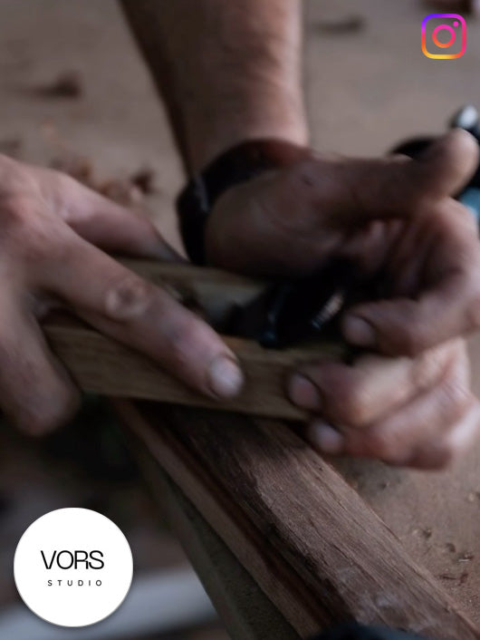 Close-up of hands using a Kakuri hand plane on wood.